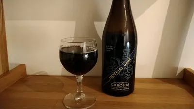 A bottle of and a glass with, "Gouden Carolus Cuvée van de Keizer Imperial Dark (2021)"