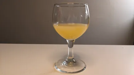 Mango mead in a wine glass