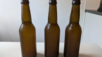 Close up of three brown glass bottles.