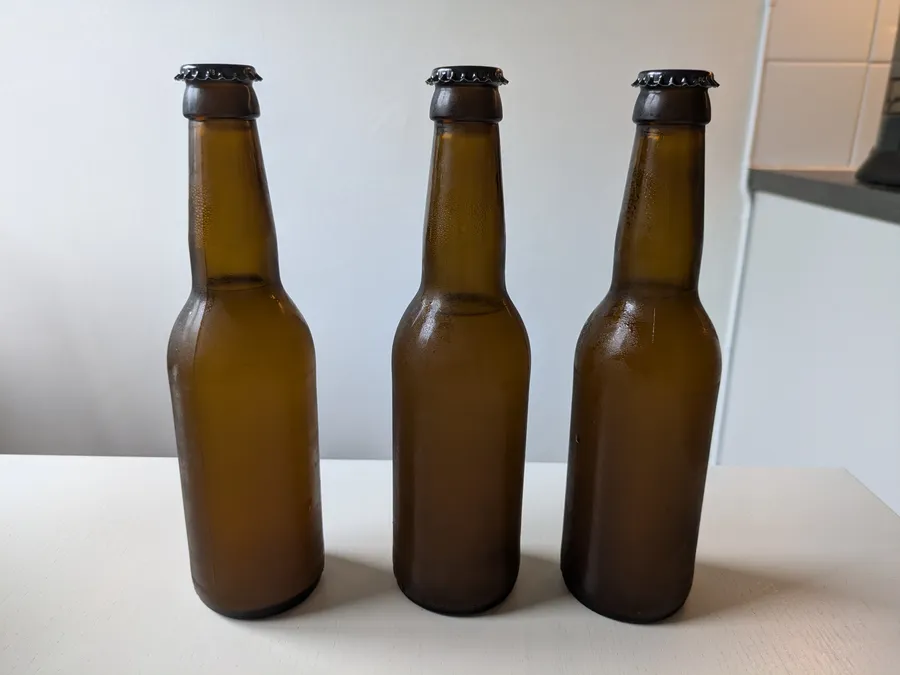 Close up of three brown glass bottles.