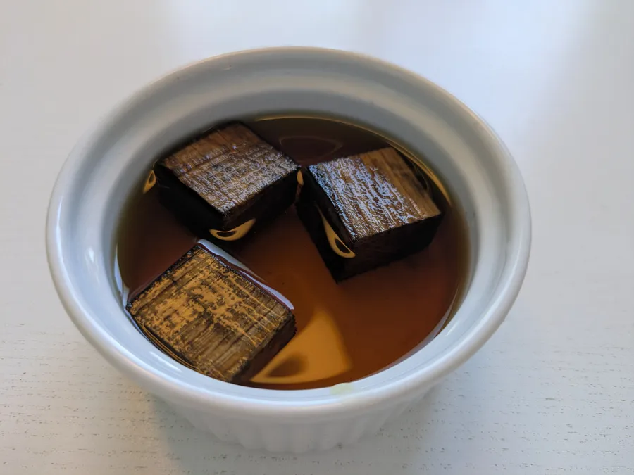 Oak cubes from a rum barrel in a bowl with cognac.